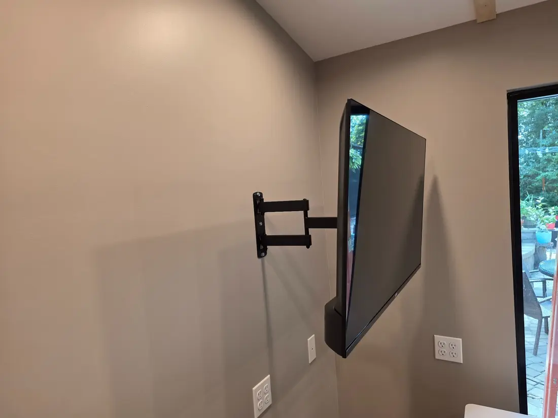 Mounted television extended and angled on its full-motion arm