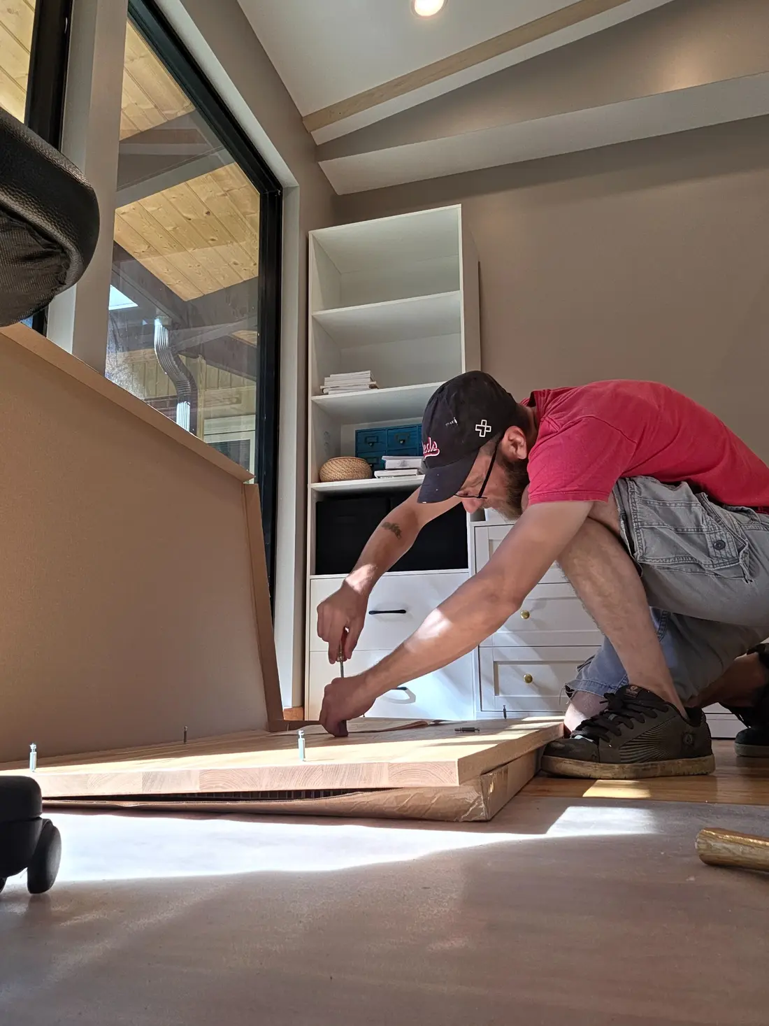 Christopher assembling flat-pack furniture while protecting the floor
