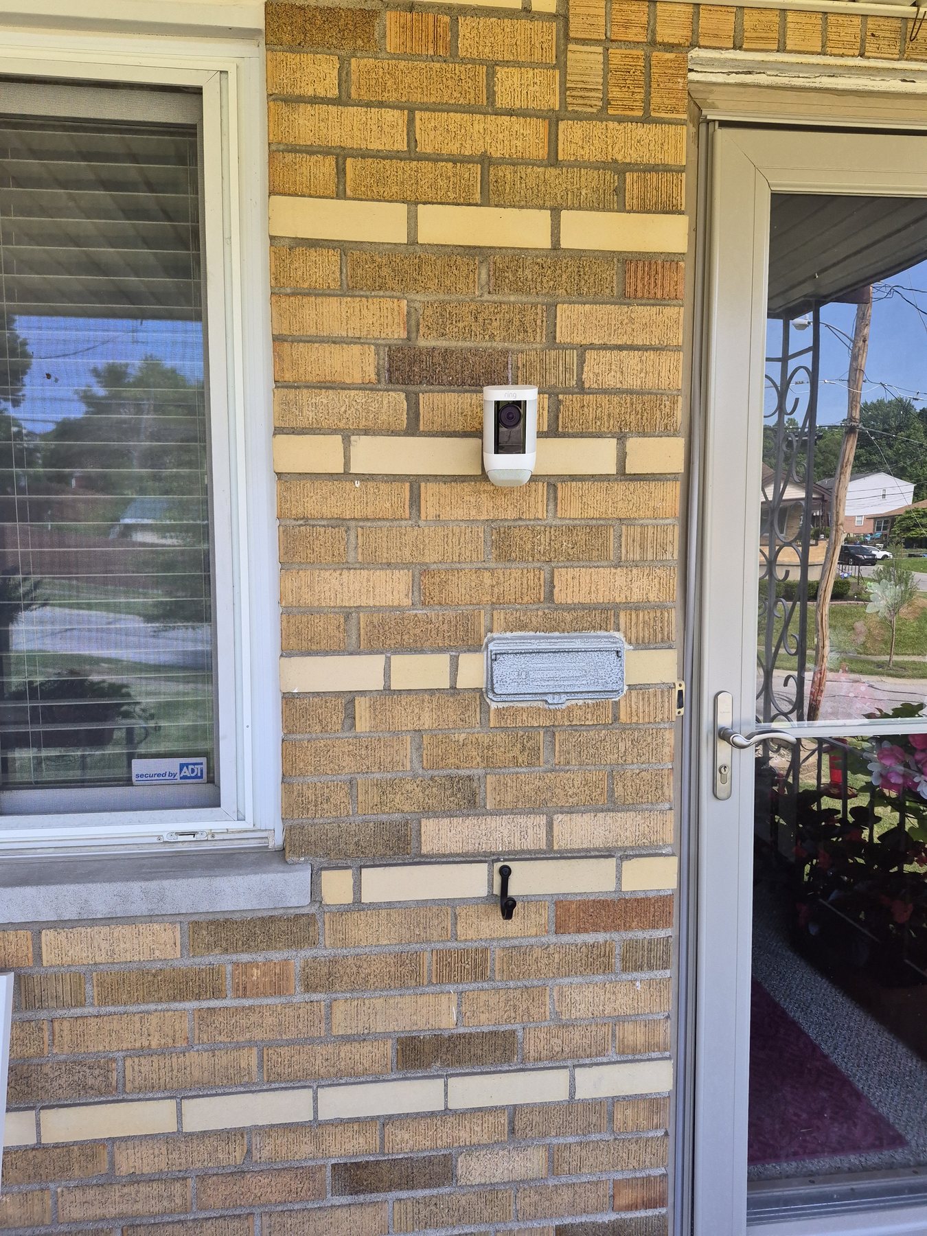 Residential Ring security camera installed on brick beside a Cincinnati entrance